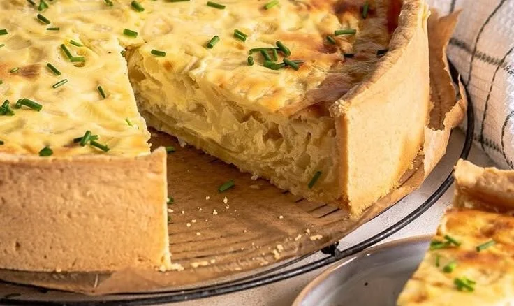 Vegetarischer Zwiebelkuchen auf einem Teller serviert.
